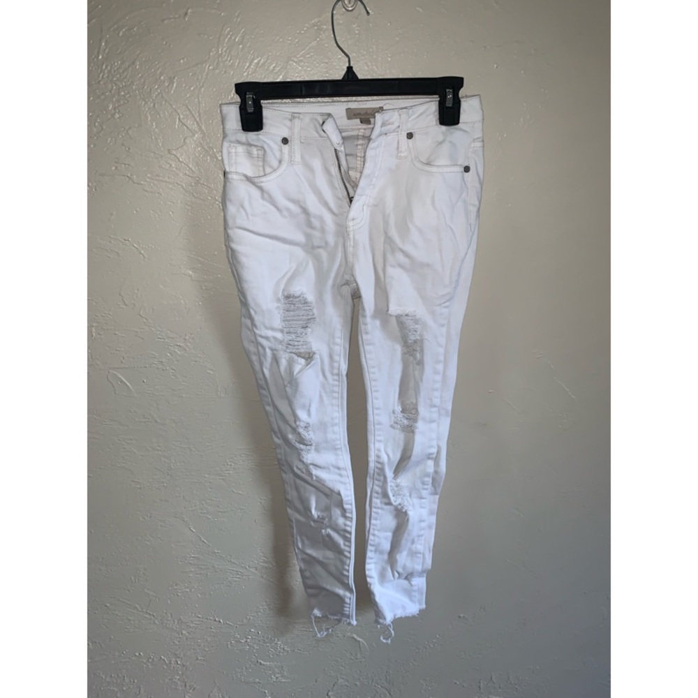 Distressed white jeans